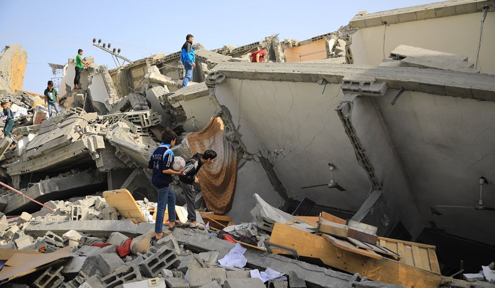 Palestinians searching rubble of collapsed building