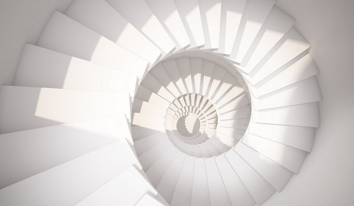 A white spiral staircase from above